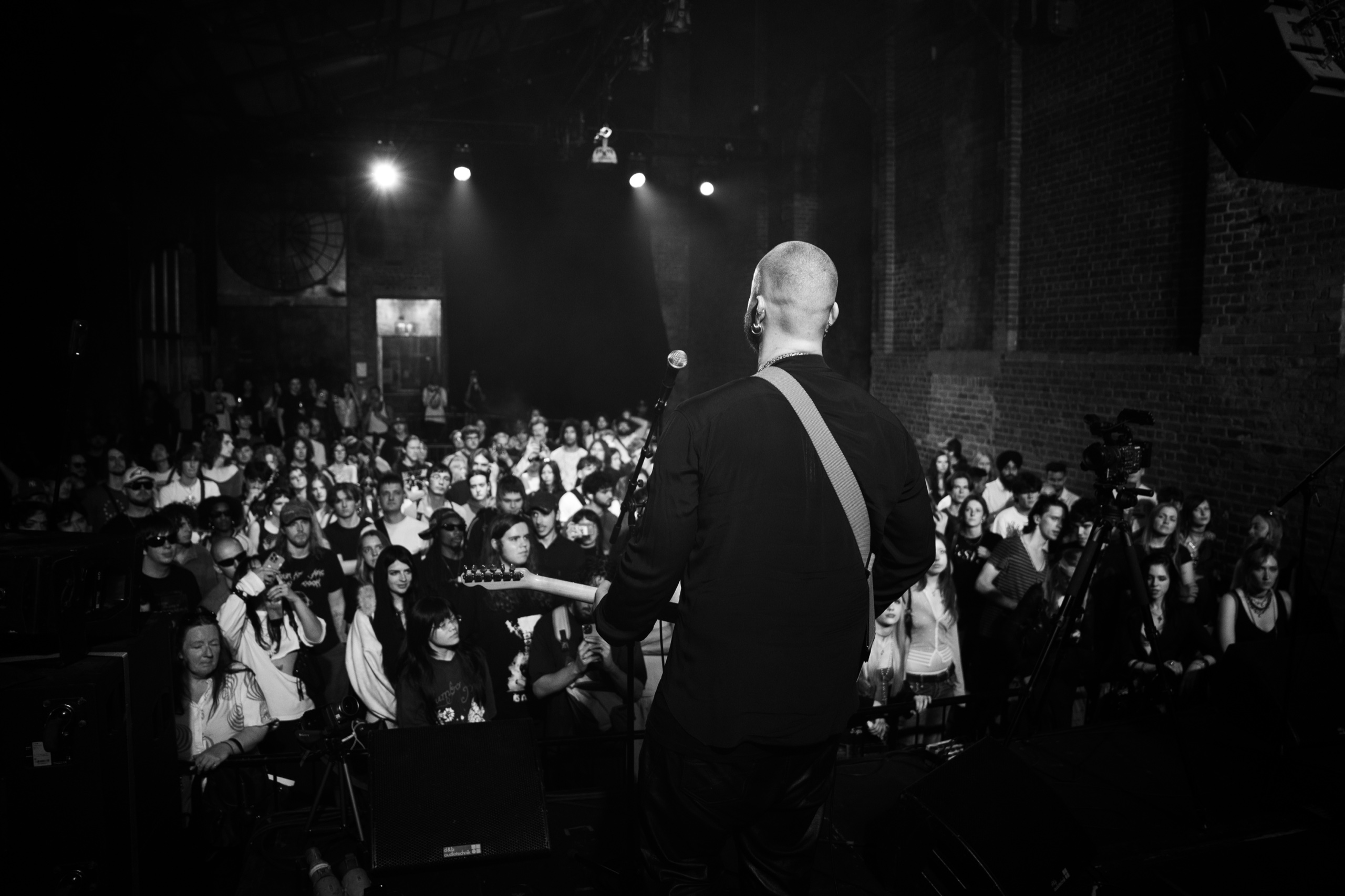 Felix Lee on stage facing the crowd at Village Underground